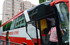 Autobus w barach biało-czerwonych z napisem &quot;Ambulans do pobierania krwi&quot;.